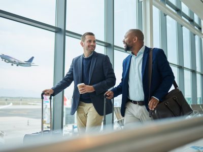 Travel for business, team at airport and men, catch flight for work trip with conference or training seminar with accountant. Walk, talk and diversity with finance convention and partnership